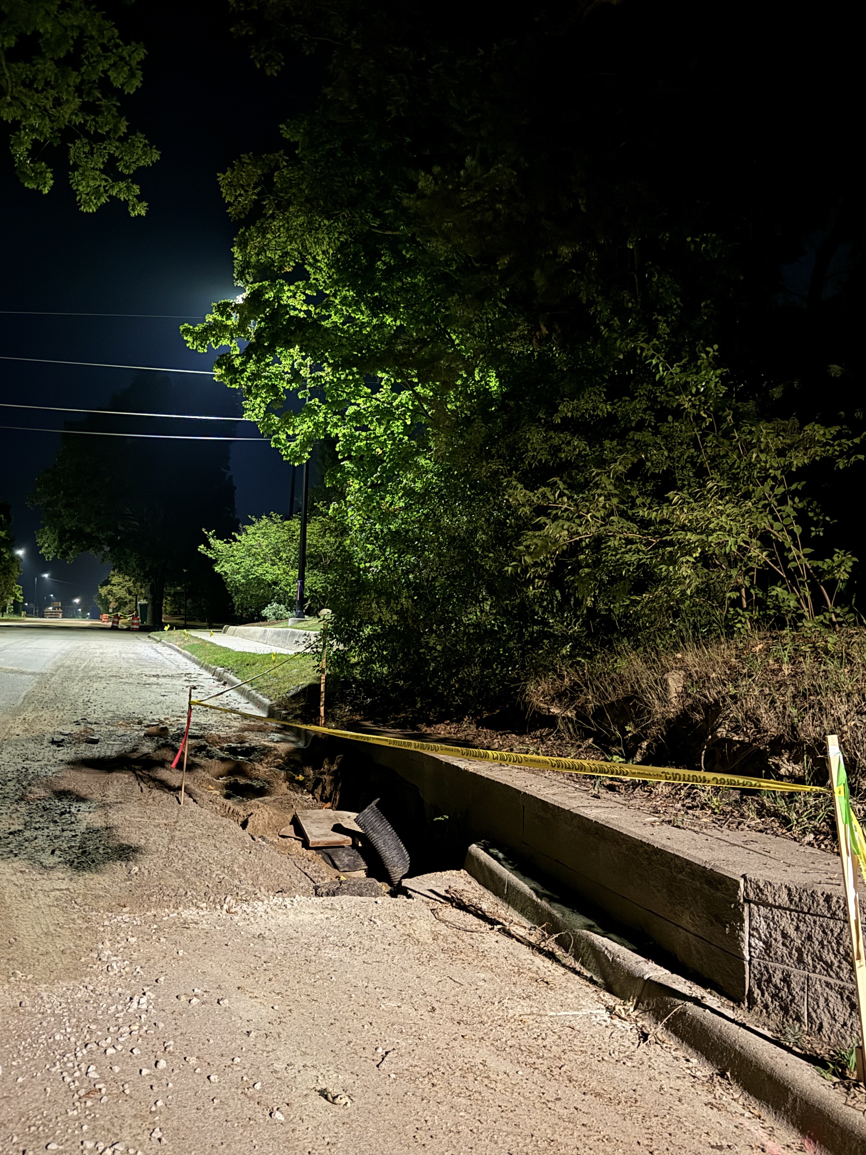 The excavation at the curb showing the cut face and drain pipe